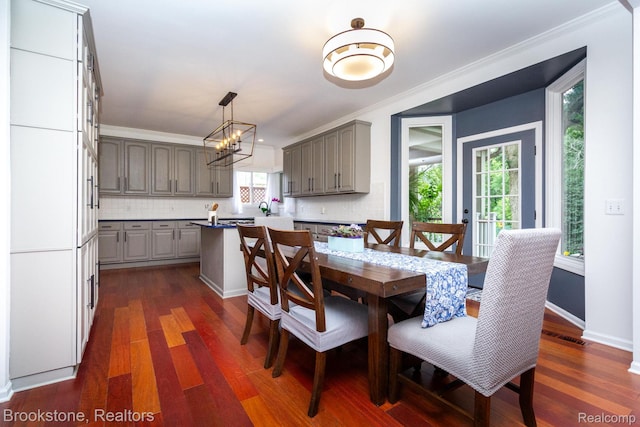 3845 Beechcrest, Rochester Hills, MI 48309 - dining space with dark wood-style floors, crown molding, and a chandelier