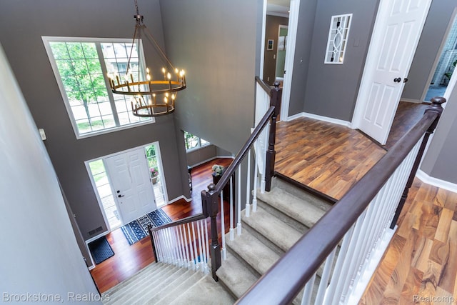 3845 Beechcrest, Rochester Hills, MI 48309 - entrance foyer with wood finished floors, a chandelier, a towering ceiling, and stairway