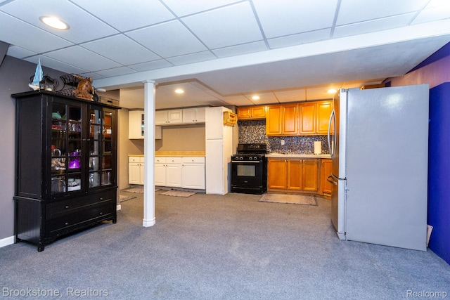 3845 Beechcrest, Rochester Hills, MI 48309 - kitchen with black gas range, freestanding refrigerator, light carpet, recessed lighting, and brown cabinetry