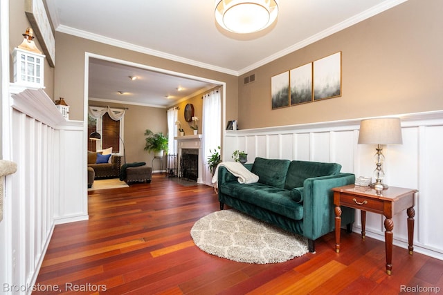 3845 Beechcrest, Rochester Hills, MI 48309 - living room with wood finished floors, ornamental molding, a fireplace with flush hearth, a wainscoted wall, and a decorative wall