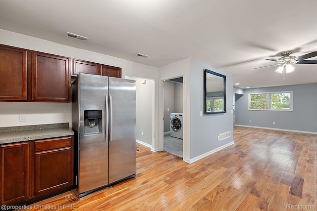 8873 Lagoon Dr, Brighton, MI 48116 - kitchen featuring stainless steel fridge, washer / dryer, a ceiling fan, and light wood finished floors