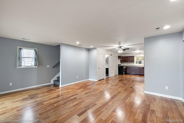 8873 Lagoon Dr, Brighton, MI 48116 - unfurnished living room featuring stairs, light wood-style floors, ceiling fan, and recessed lighting