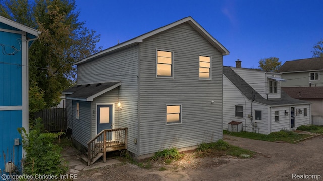 8873 Lagoon Dr, Brighton, MI 48116 - rear view of property with a shingled roof