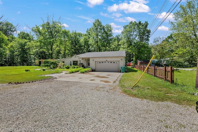 45055 Mcbride Ave, Van Buren, MI 48111 - view of front of property with driveway, a garage, and view of scattered trees