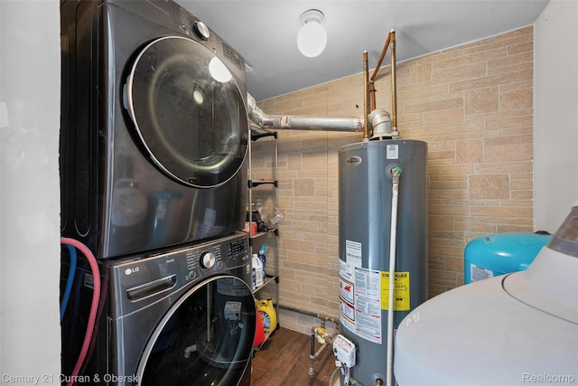 45055 Mcbride Ave, Van Buren, MI 48111 - washroom featuring water heater, stacked washing machine and dryer, and wood finished floors