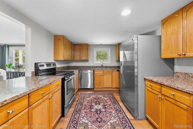 45055 Mcbride Ave, Van Buren, MI 48111 - kitchen featuring appliances with stainless steel finishes, light wood finished floors, and plenty of natural light