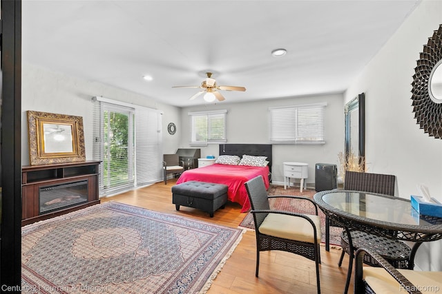 45055 Mcbride Ave, Van Buren, MI 48111 - bedroom featuring access to outside, wood finished floors, a glass covered fireplace, recessed lighting, and ceiling fan