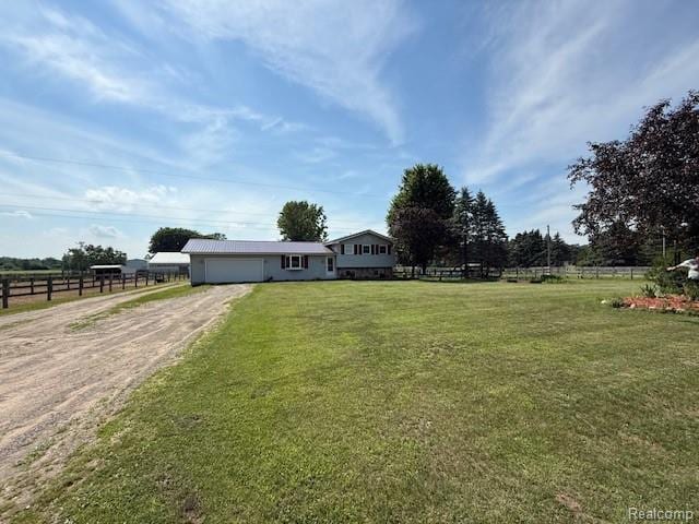 3120 Bruisee Rd, Marlette, MI 48723 - view of yard with dirt driveway, a garage, and a view of countryside