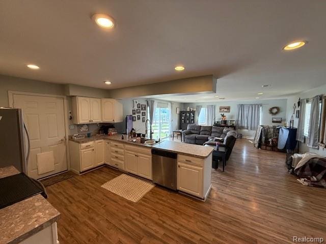 3120 Bruisee Rd, Marlette, MI 48723 - kitchen featuring stainless steel dishwasher, freestanding refrigerator, a peninsula, open floor plan, and dark wood-style flooring