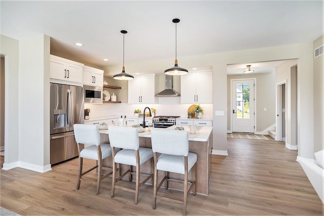 9088 N 34th St, Richland, MI 49083 - kitchen with appliances with stainless steel finishes, wall chimney range hood, light countertops, open shelves, and tasteful backsplash