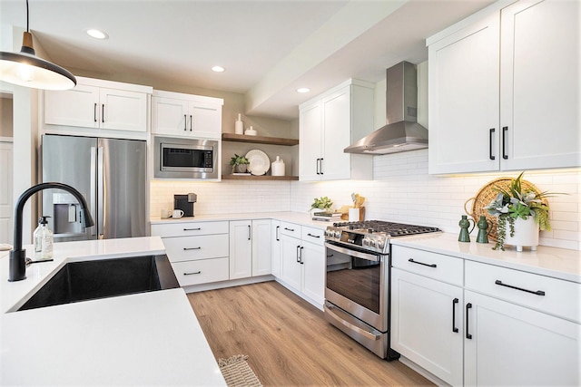 9088 N 34th St, Richland, MI 49083 - kitchen featuring wall chimney exhaust hood, appliances with stainless steel finishes, open shelves, light countertops, and white cabinetry
