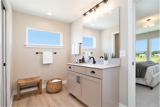 9088 N 34th St, Richland, MI 49083 - bathroom featuring vanity, connected bathroom, plenty of natural light, wood finished floors, and recessed lighting