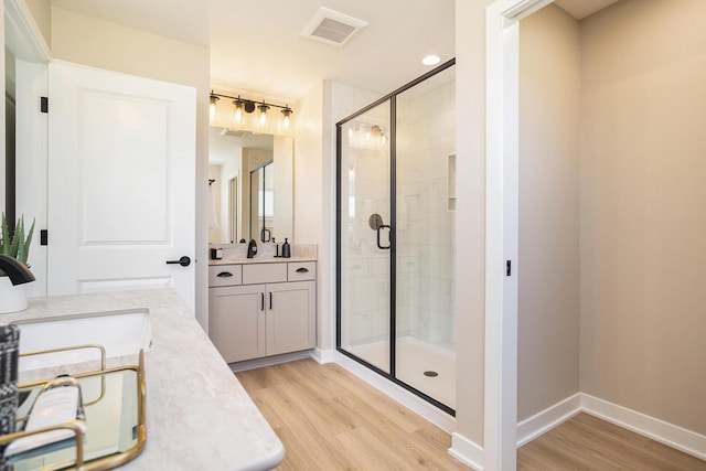 9088 N 34th St, Richland, MI 49083 - full bath with wood finished floors, two vanities, and a stall shower