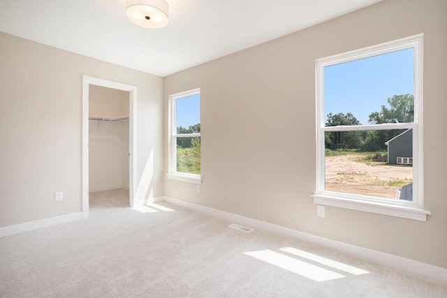 9088 N 34th St, Richland, MI 49083 - unfurnished bedroom with carpet flooring, a spacious closet, and a closet