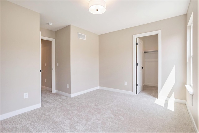 9088 N 34th St, Richland, MI 49083 - unfurnished bedroom with light colored carpet, a spacious closet, and a closet