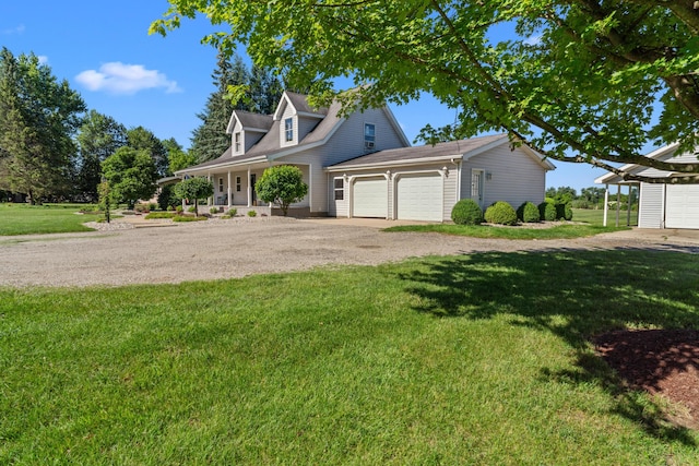 5160 Barker Rd, Jonesville, MI 49250 - view of front facade with driveway, an attached garage, a front yard, and covered porch