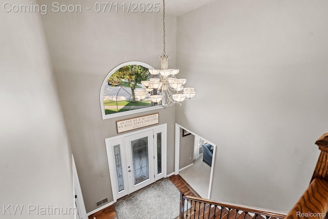 4317 Vassar Dr, Troy, MI 48085 - foyer entrance featuring a high ceiling, a chandelier, and wood finished floors