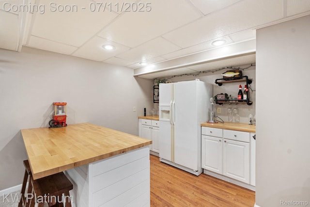 4317 Vassar Dr, Troy, MI 48085 - kitchen featuring white refrigerator with ice dispenser, wooden counters, open shelves, white cabinets, and light wood-type flooring