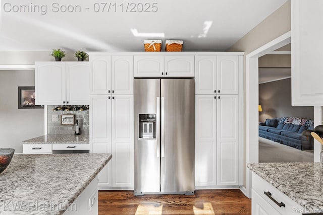 4317 Vassar Dr, Troy, MI 48085 - kitchen with stainless steel fridge with ice dispenser, white cabinetry, dark wood finished floors, light stone counters, and tasteful backsplash