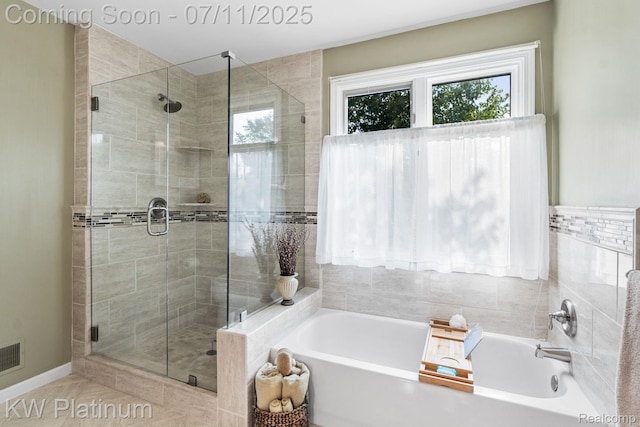 4317 Vassar Dr, Troy, MI 48085 - bathroom with healthy amount of natural light, a garden tub, and a stall shower