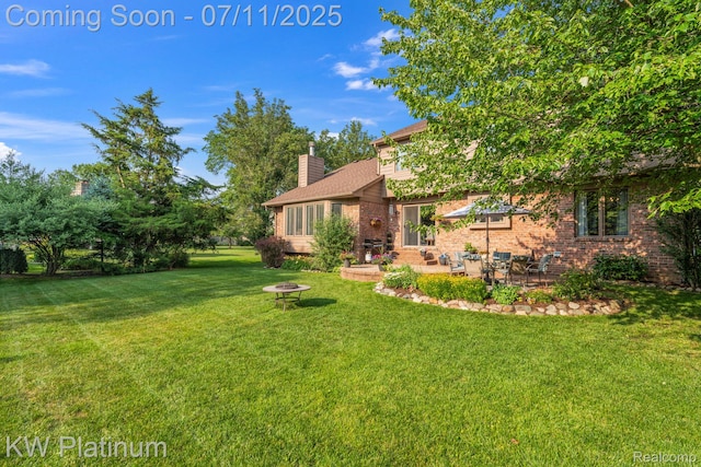4317 Vassar Dr, Troy, MI 48085 - view of grassy yard featuring a patio and a fire pit