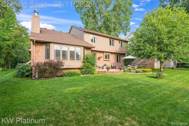 4317 Vassar Dr, Troy, MI 48085 - rear view of house featuring a yard, a patio area, a chimney, brick siding, and a shingled roof