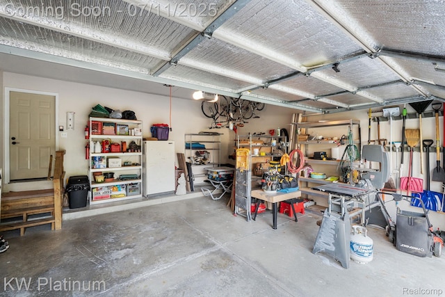 4317 Vassar Dr, Troy, MI 48085 - garage with a garage door opener and a workshop area