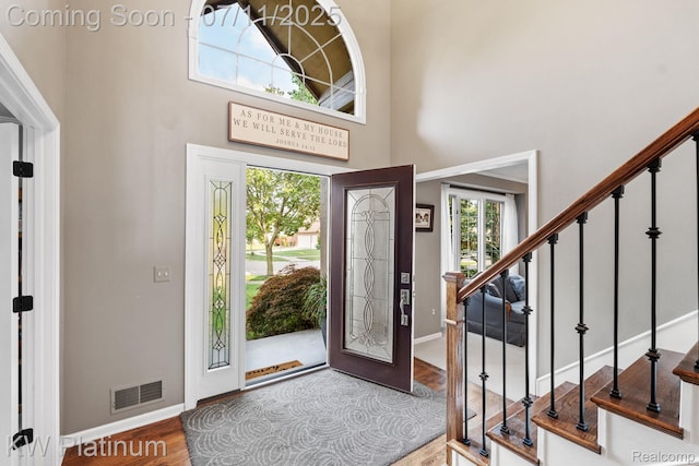 4317 Vassar Dr, Troy, MI 48085 - foyer entrance featuring plenty of natural light, wood finished floors, stairway, and a high ceiling