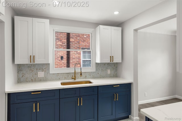 19777 Santa Rosa Dr, Detroit, MI 48221 - kitchen featuring blue cabinets, wood finished floors, white cabinets, backsplash, and recessed lighting