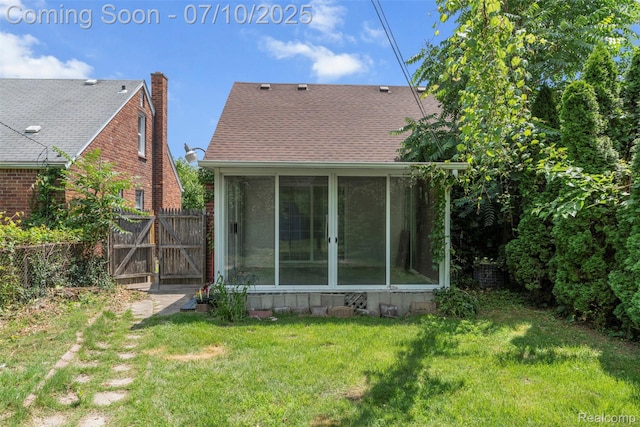 19777 Santa Rosa Dr, Detroit, MI 48221 - back of property with a sunroom and a gate