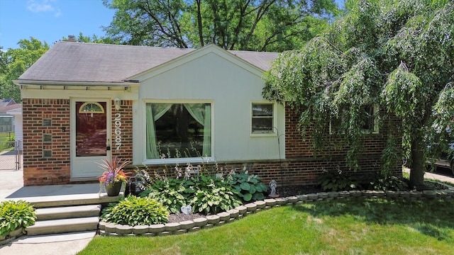 29687 Westfield St, Livonia, MI 48150 - view of front of house with brick siding, a front lawn, and roof with shingles