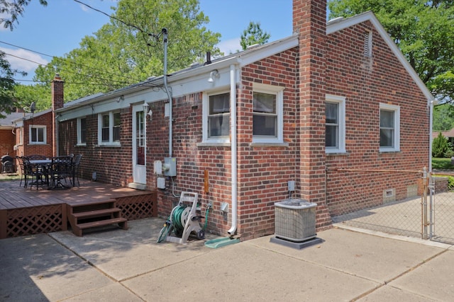 29687 Westfield St, Livonia, MI 48150 - back of property with a chimney, brick siding, and a deck