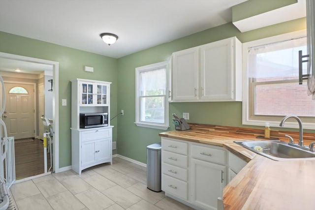 29687 Westfield St, Livonia, MI 48150 - kitchen with stainless steel microwave, wooden counters, and white cabinetry