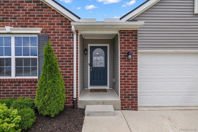 58565 Westmoore Cir, New Haven, MI 48048 - doorway to property with brick siding and an attached garage