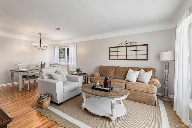 1820 W Longmeadow Rd, Trenton, MI 48183 - living area featuring a chandelier and light wood-type flooring