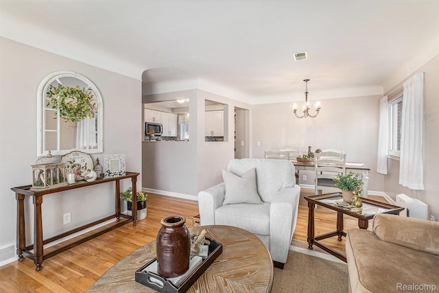 1820 W Longmeadow Rd, Trenton, MI 48183 - living area featuring a chandelier and light wood-style floors