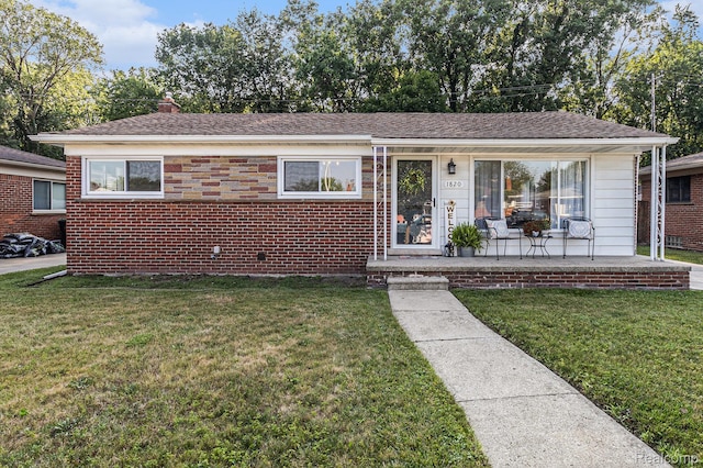 1820 W Longmeadow Rd, Trenton, MI 48183 - view of front of property featuring a front lawn and brick siding