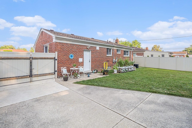 1820 W Longmeadow Rd, Trenton, MI 48183 - rear view of property featuring brick siding, a gate, and a chimney