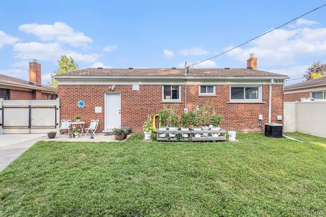 1820 W Longmeadow Rd, Trenton, MI 48183 - rear view of property with a gate, brick siding, a patio, and a chimney