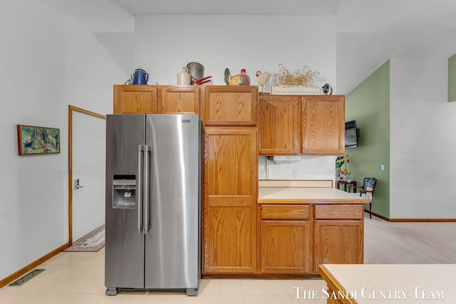 15071 Steves Dr, Grand Haven, MI 49417 - kitchen featuring high end refrigerator, light countertops, and brown cabinets