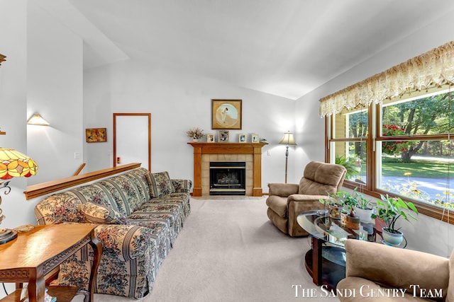 15071 Steves Dr, Grand Haven, MI 49417 - carpeted living area featuring lofted ceiling and a tiled fireplace