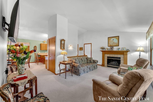15071 Steves Dr, Grand Haven, MI 49417 - living area featuring light carpet, vaulted ceiling, and a tile fireplace