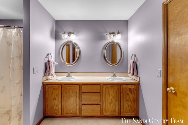 15071 Steves Dr, Grand Haven, MI 49417 - bathroom with double vanity and baseboards