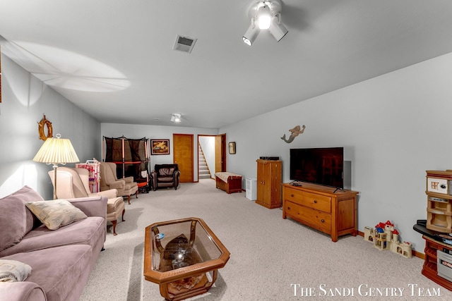 15071 Steves Dr, Grand Haven, MI 49417 - living area featuring carpet floors, stairs, and ceiling fan