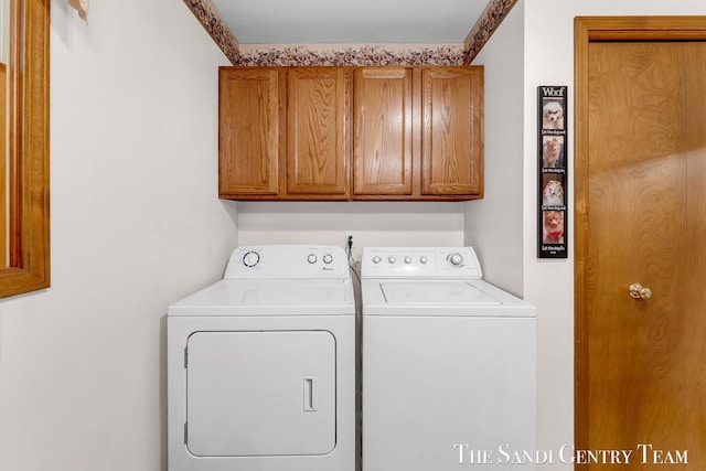 15071 Steves Dr, Grand Haven, MI 49417 - laundry area with cabinet space and washing machine and clothes dryer