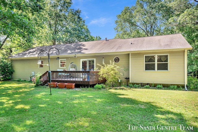 15071 Steves Dr, Grand Haven, MI 49417 - rear view of property with a wooden deck and a lawn