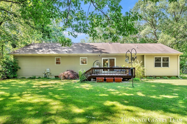 15071 Steves Dr, Grand Haven, MI 49417 - back of house featuring a lawn and a deck