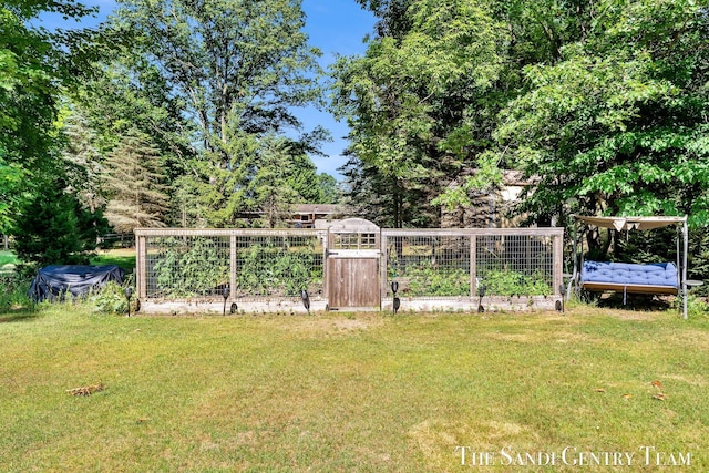 15071 Steves Dr, Grand Haven, MI 49417 - view of grassy yard with a garden