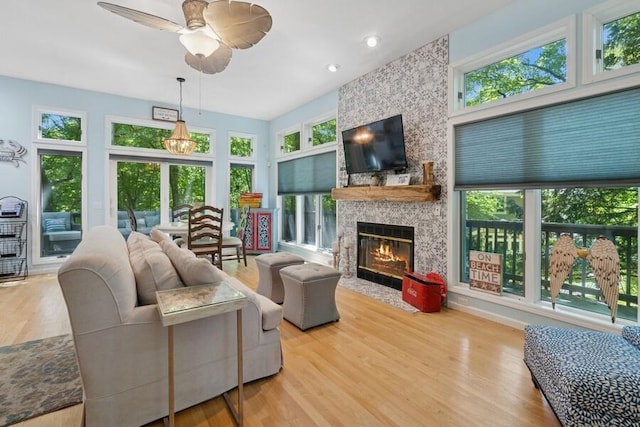 613 Indian Trl, Sawyer, MI 49125 - living room featuring a stone fireplace, a ceiling fan, wood finished floors, and recessed lighting