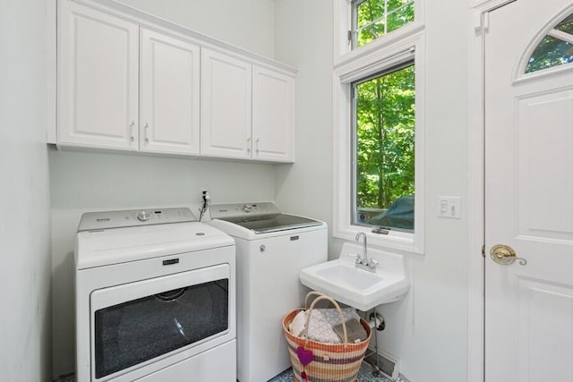 613 Indian Trl, Sawyer, MI 49125 - laundry area with independent washer and dryer, cabinet space, and plenty of natural light